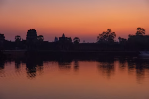 Sunrise behind Angkor Wat at 6am, view from outside the moat