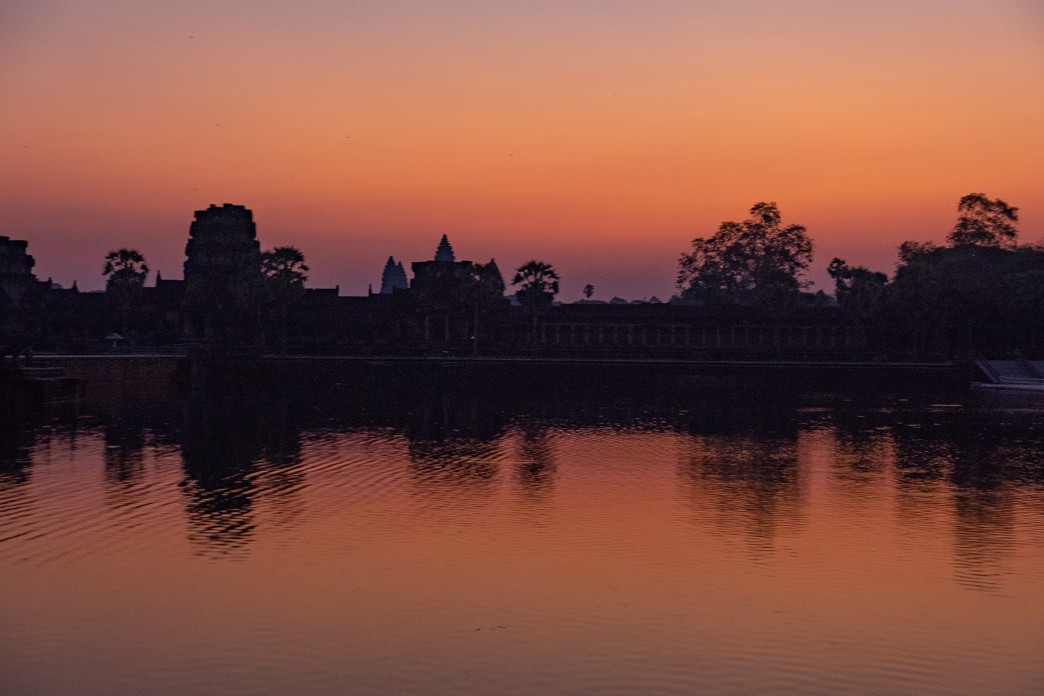 Sunrise behind Angkor Wat at 6am, view from outside the moat